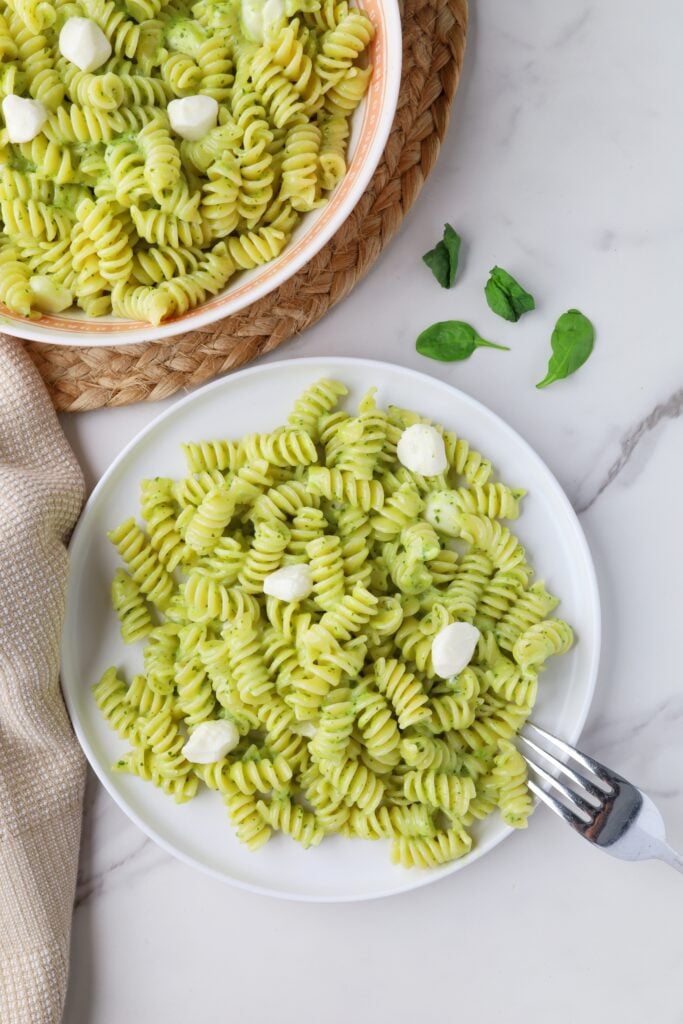 Creamy pesto pasta on a white plate