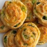 Delicious broccoli cheese pinwheels on a white plate