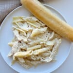 Olive garden chicken pasta on a plate with a breadstick