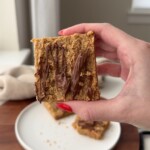 A hand holding up a healthy apple oat bar