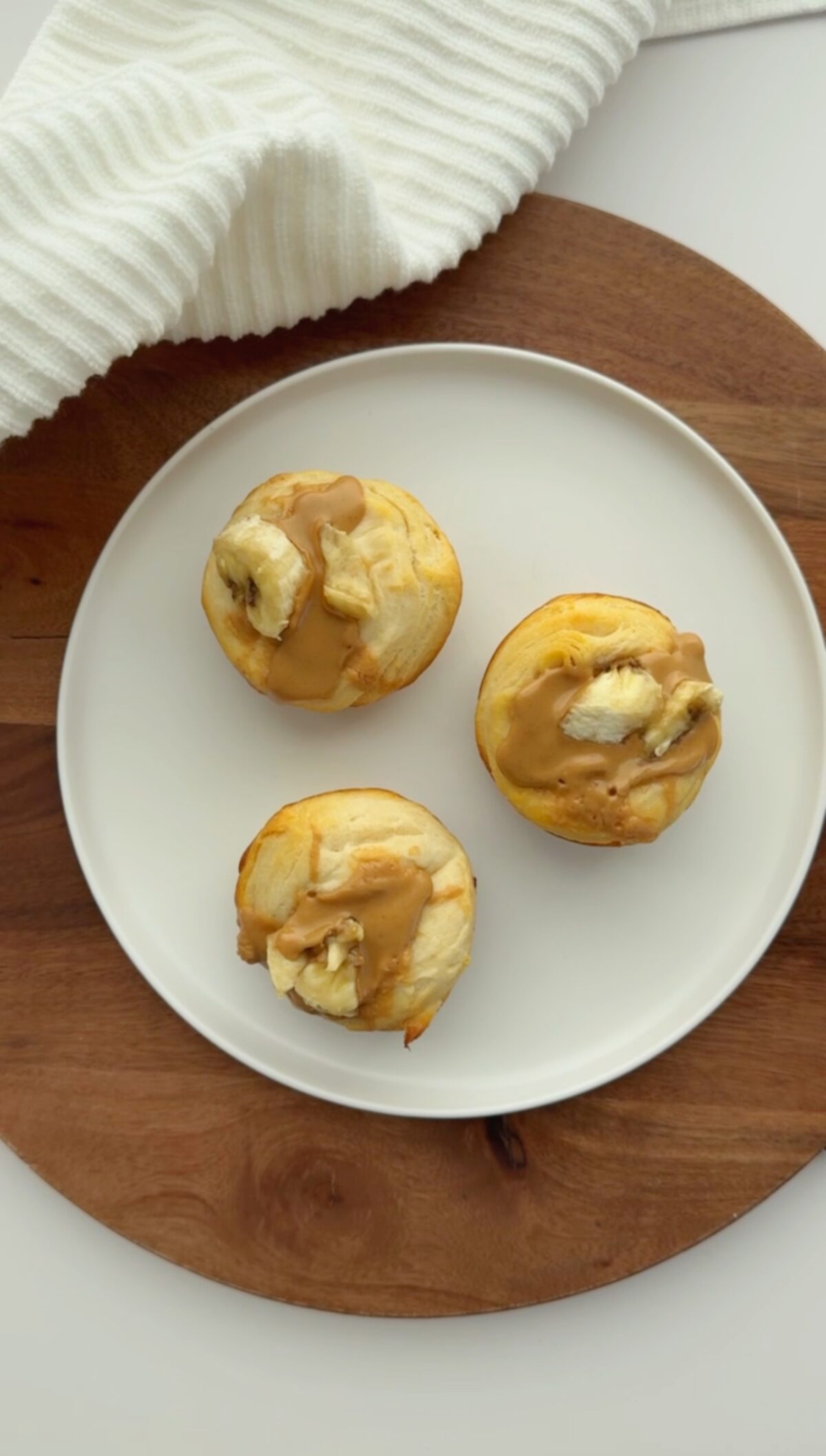 Three toddler-friendly Peanut Butter Banana Biscuits on a white plate
